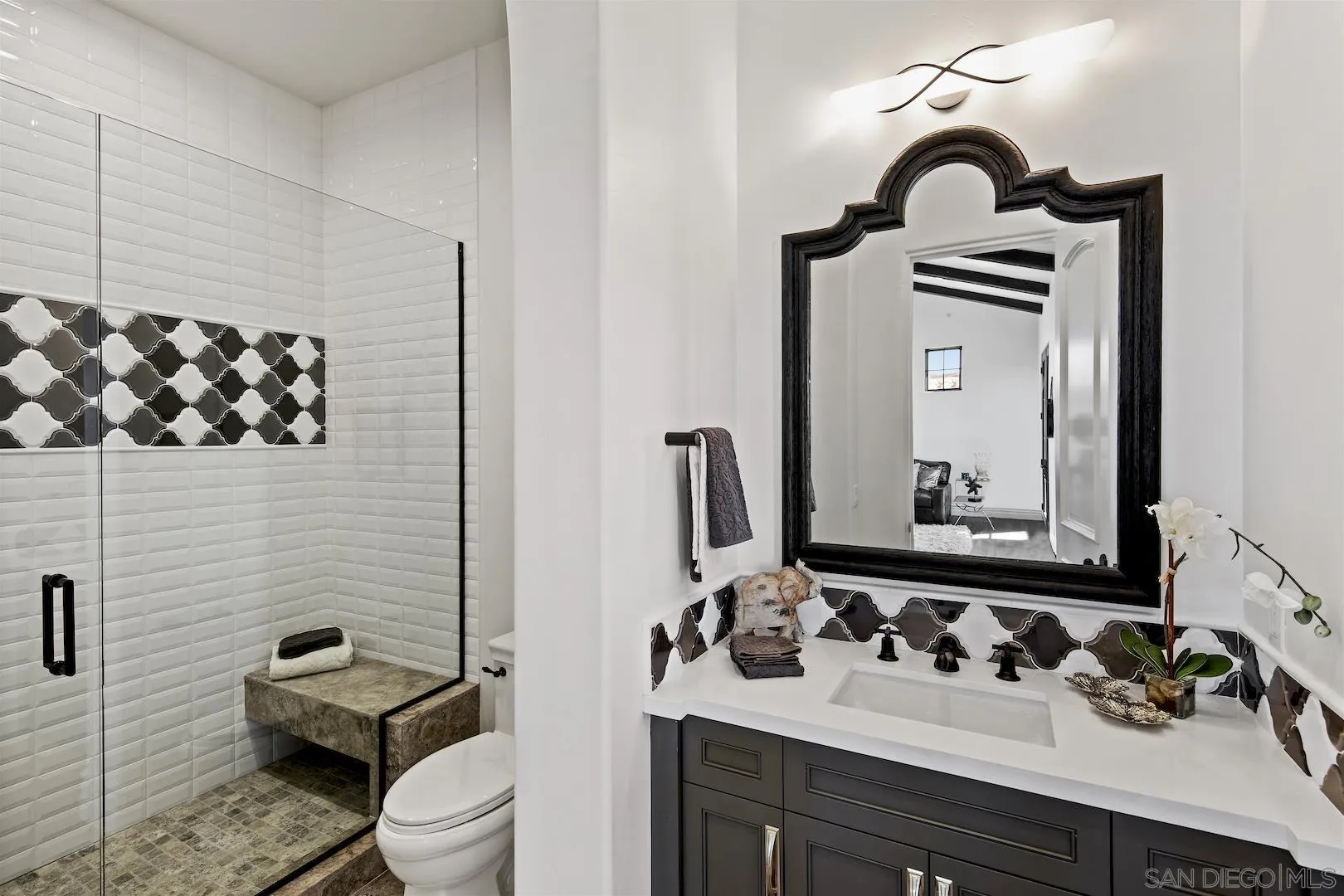 14304 Ridge Ranch Road Valley Center, CA 92082 - Photo 23 of 30 a bathroom with a toilet sink vanity and mirror