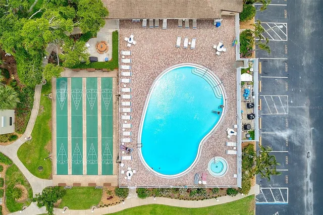a white bath tub sitting in a yard with potted plants