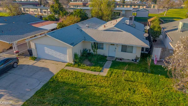 a aerial view of a house with a yard