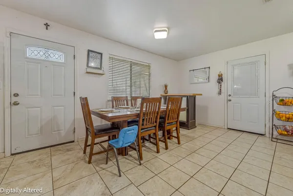 a dining room filled with furniture and a potted plant
