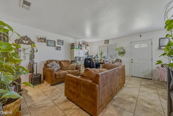 a kitchen with granite countertop a sink and a refrigerator