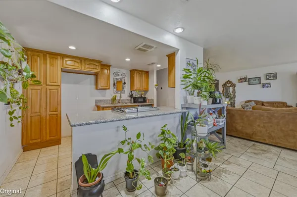 a kitchen with stainless steel appliances granite countertop a sink stove and cabinets