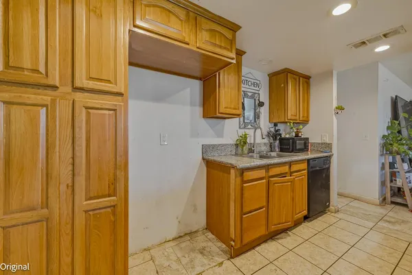 a kitchen with stainless steel appliances granite countertop a sink and cabinets