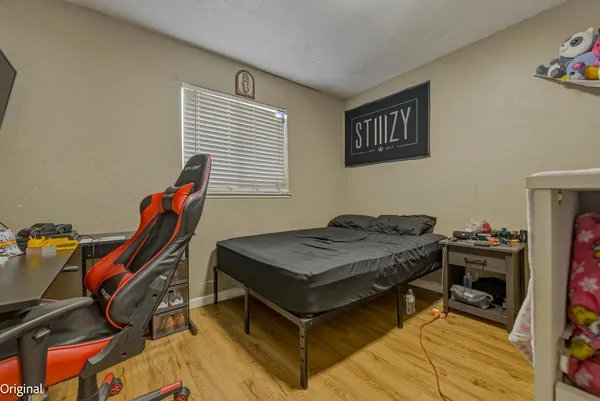 a bedroom with a bed and a window