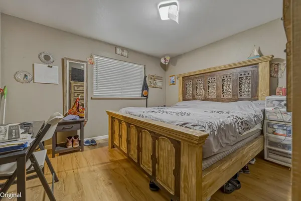 a bedroom with a bed window and a flat screen tv