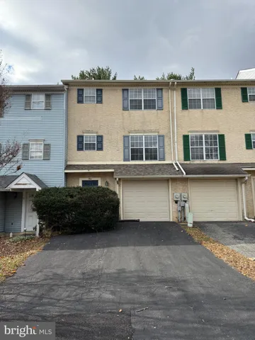 a view of a house with wooden fence