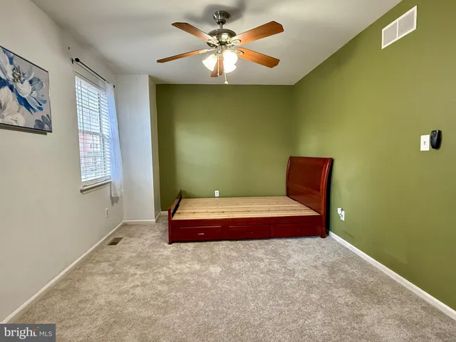 a room with furniture and a chandelier fan