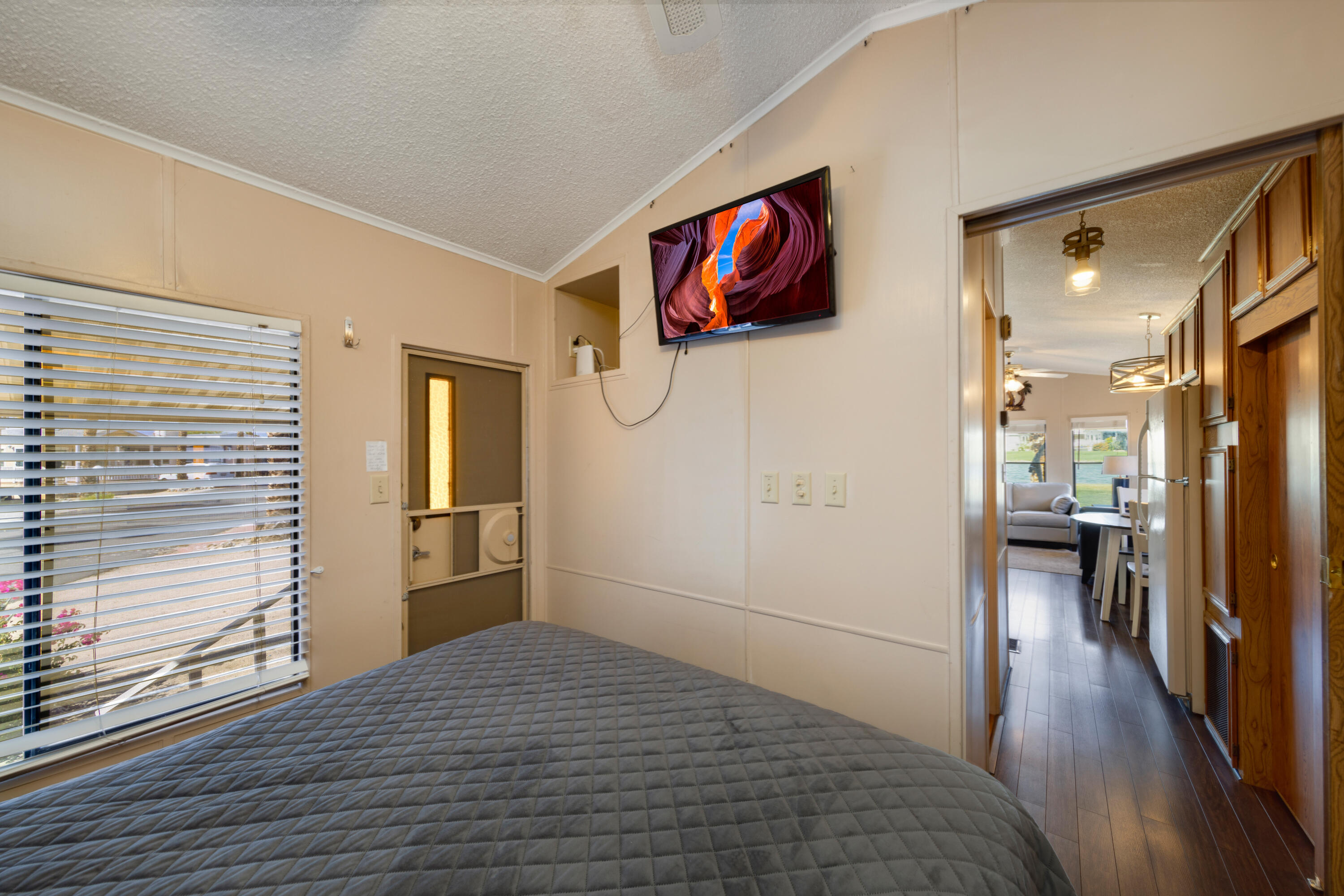 74711 Dillon Road, Unit 123 Sky Valley, CA 92241 - Photo 11 of 23 a bedroom with a bed and wooden floor