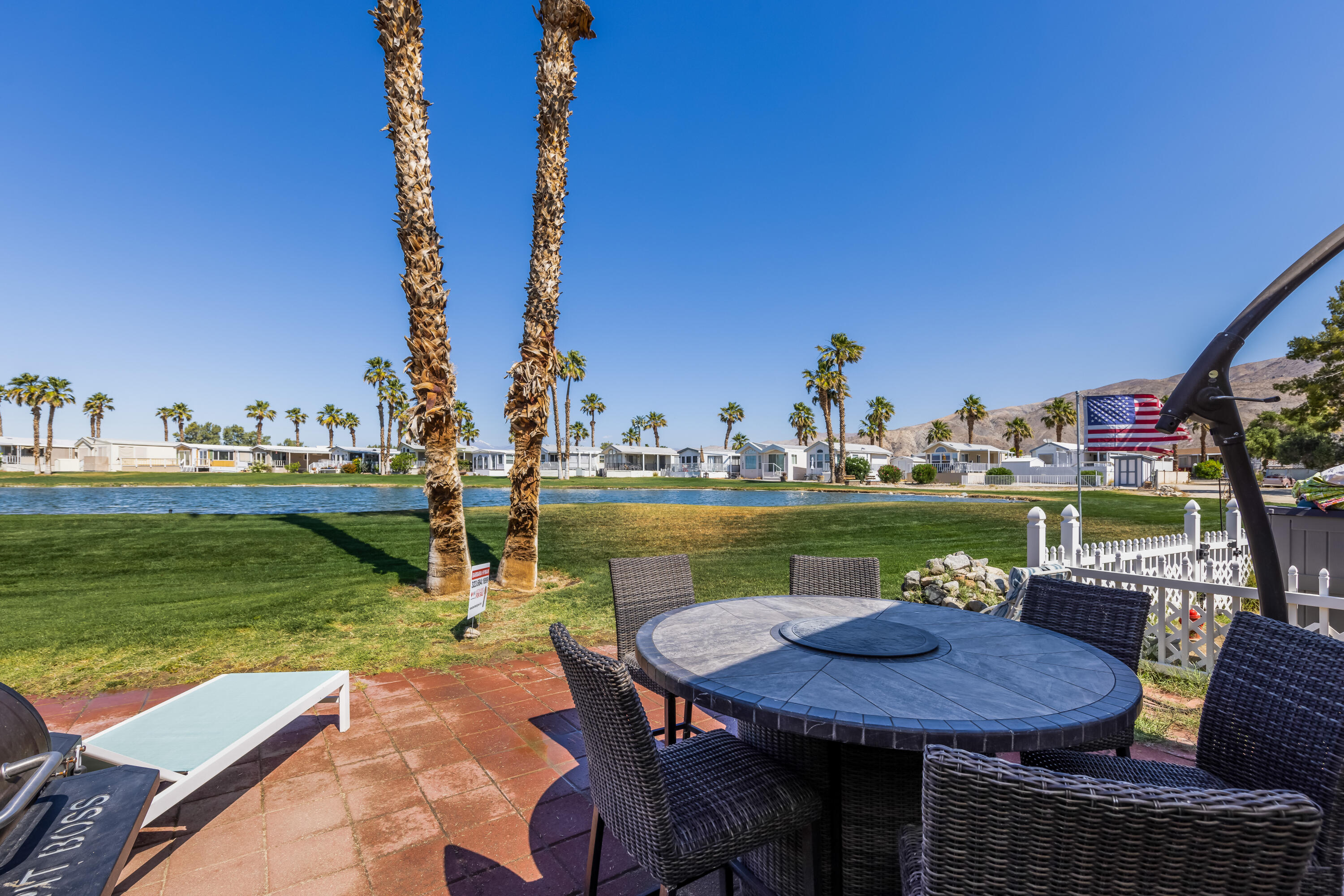74711 Dillon Road, Unit 123 Sky Valley, CA 92241 - Photo 15 of 23 a view of a lake with couches chairs and a table