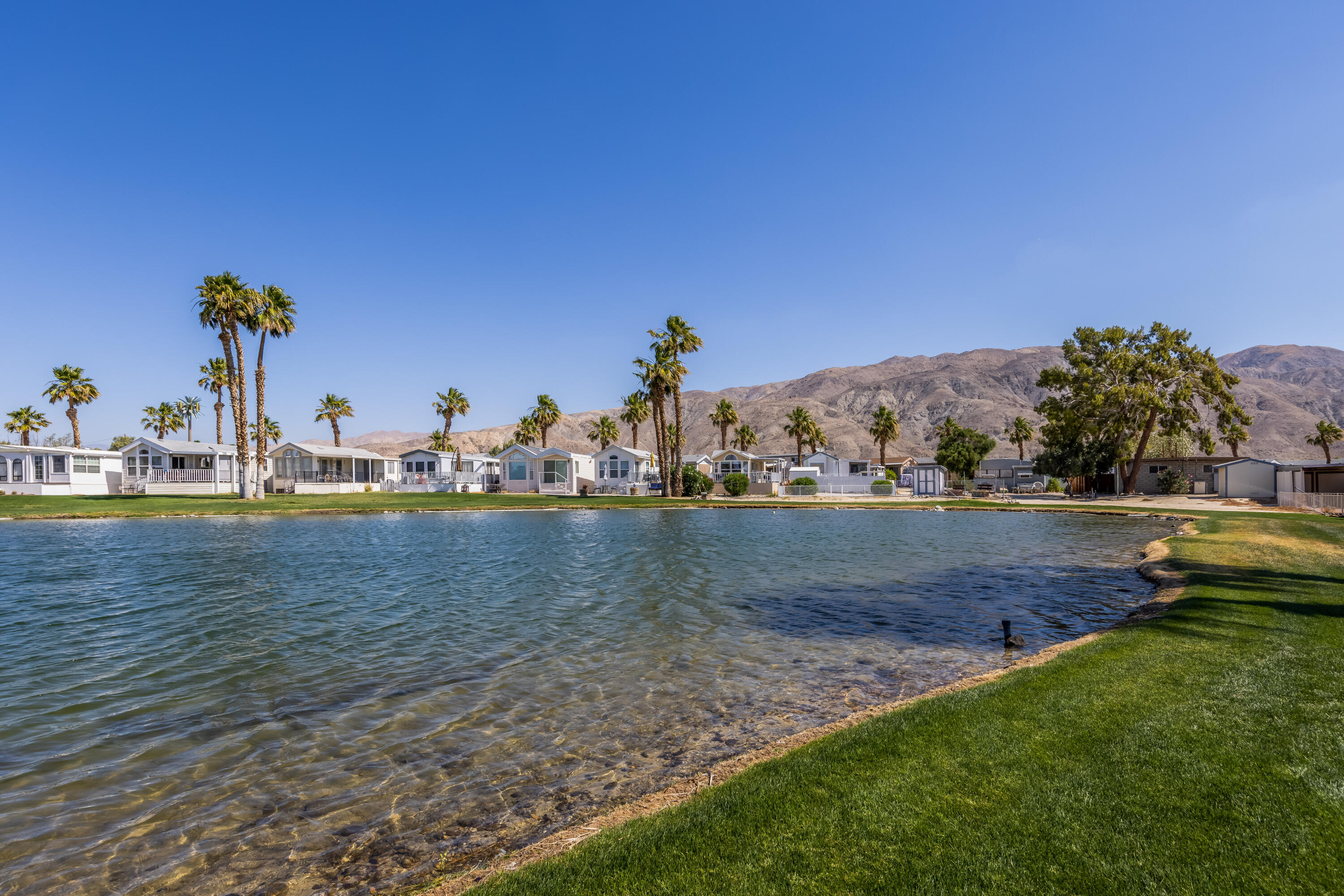 74711 Dillon Road, Unit 123 Sky Valley, CA 92241 - Photo 20 of 23 a view of a lake with houses