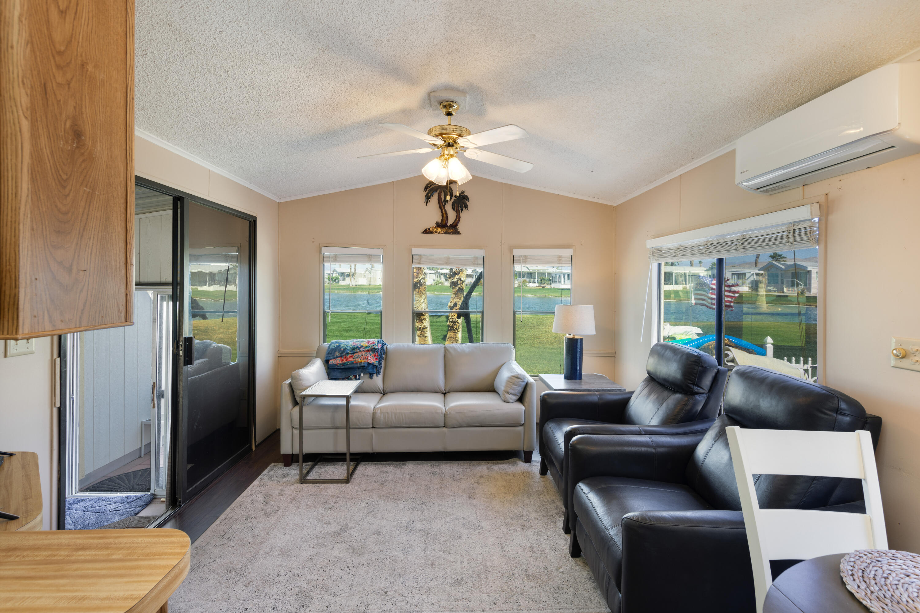 74711 Dillon Road, Unit 123 Sky Valley, CA 92241 - Photo 4 of 23 a living room with furniture a chandelier and a window