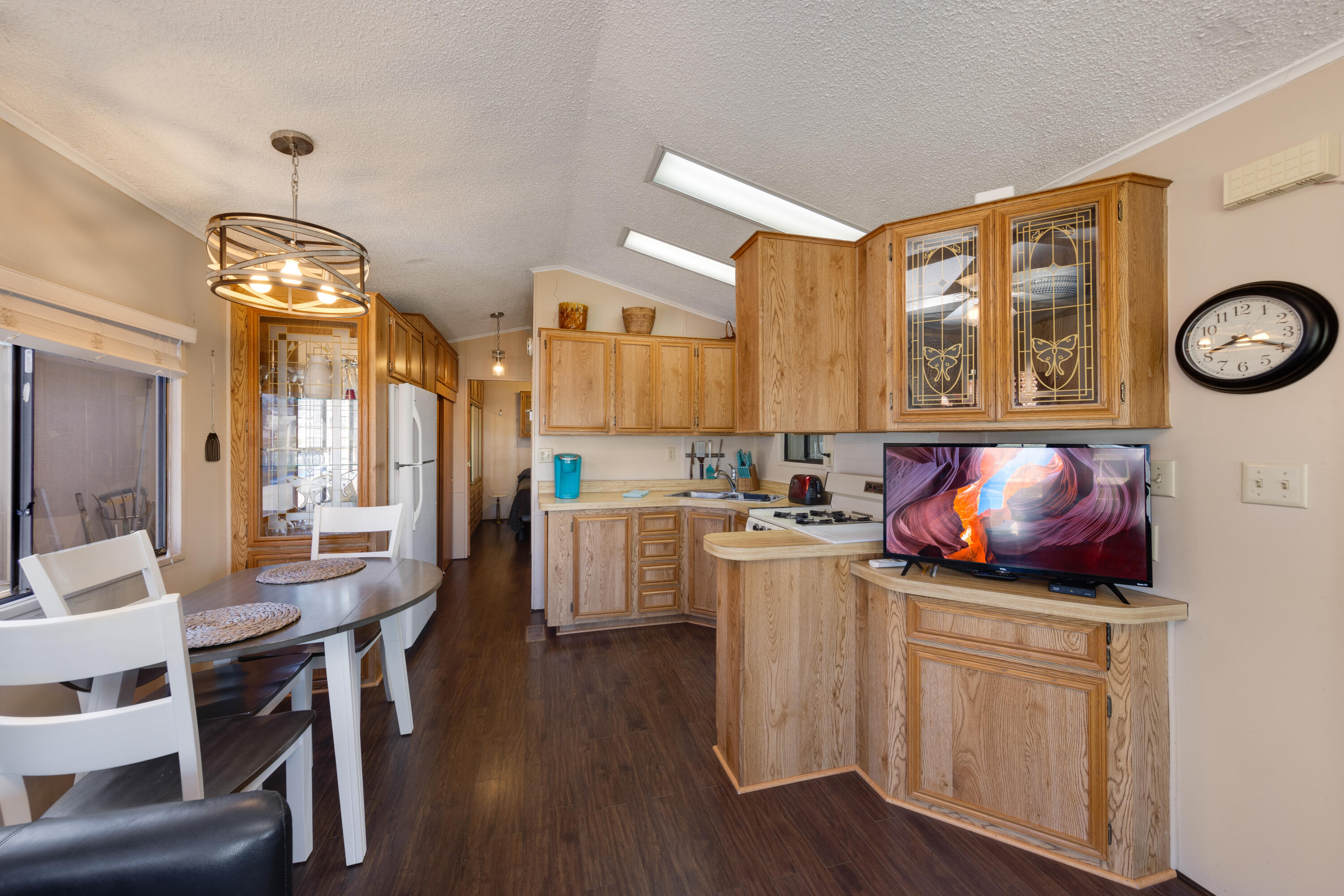 74711 Dillon Road, Unit 123 Sky Valley, CA 92241 - Photo 7 of 23 a kitchen with a table chairs and cabinets