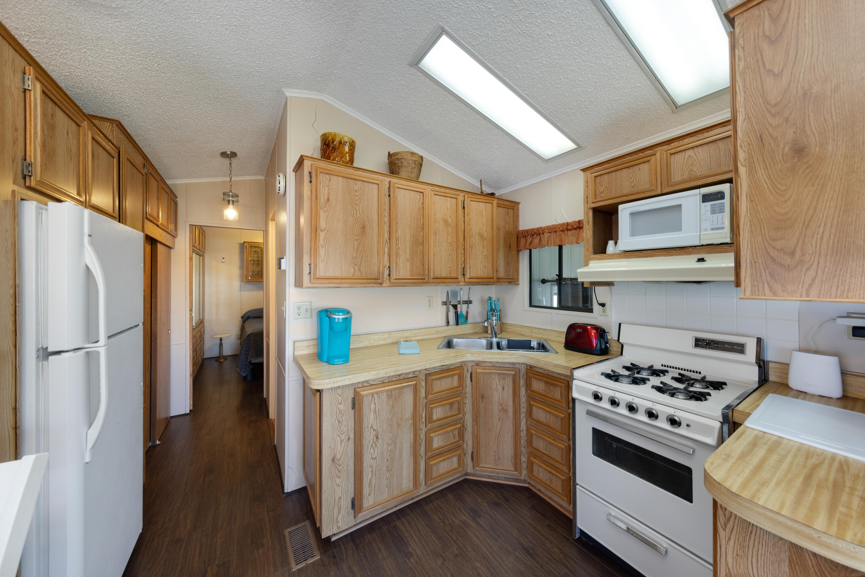 74711 Dillon Road, Unit 123 Sky Valley, CA 92241 - Photo 8 of 23 a kitchen with a white cabinets and white appliances