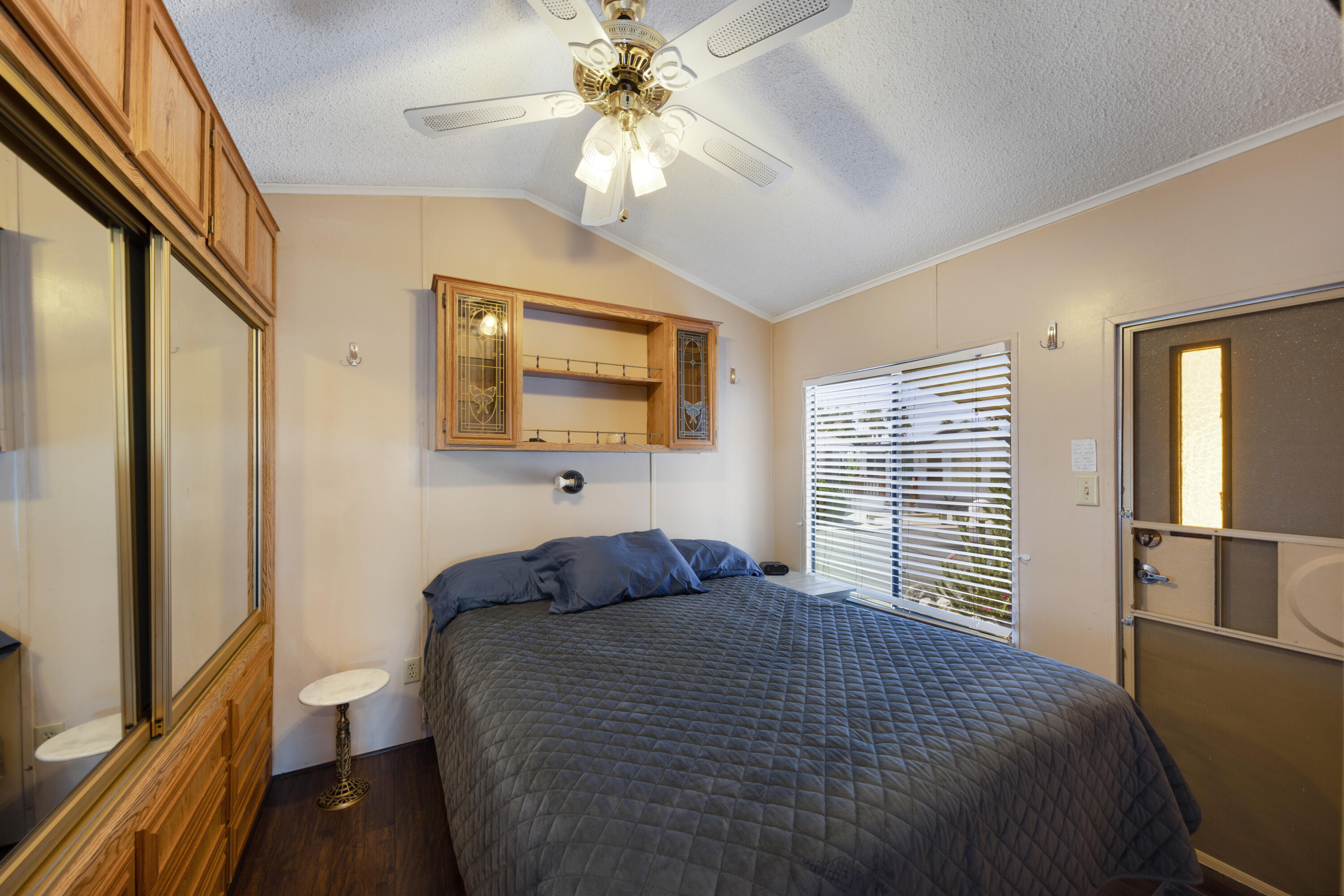 74711 Dillon Road, Unit 123 Sky Valley, CA 92241 - Photo 10 of 23 a bedroom with a large bed and a chandelier