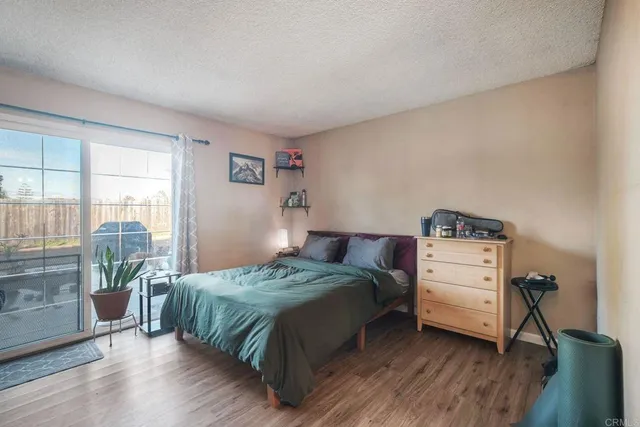 a bedroom with a bed and a wooden floor