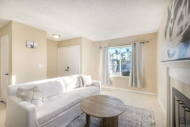 a living room with furniture and a fireplace