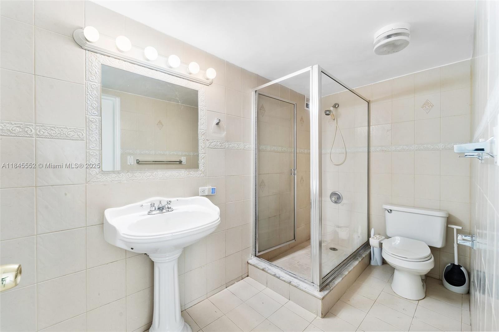 16919 North Bay Road, Unit 115 Sunny Isles Beach, FL 33160 - Photo 14 of 20 a bathroom with a sink toilet and shower