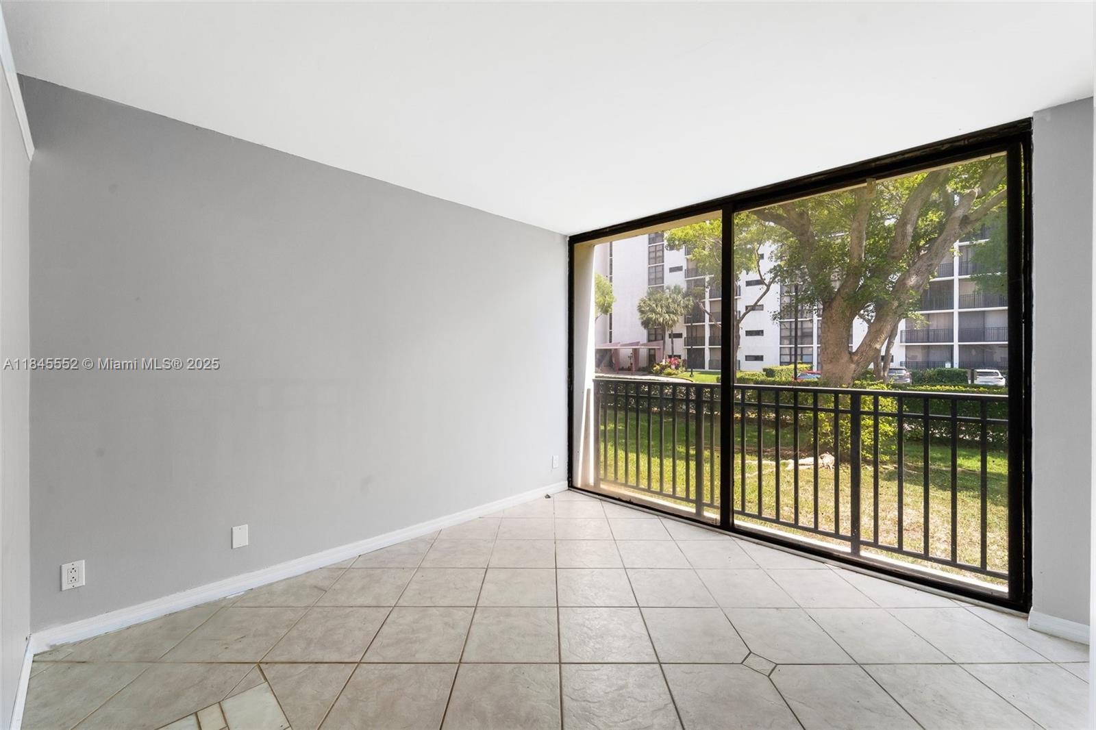 16919 North Bay Road, Unit 115 Sunny Isles Beach, FL 33160 - Photo 4 of 20 a view of a room with sliding glass door