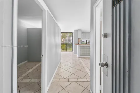 a kitchen with granite countertop a refrigerator and a stove top oven