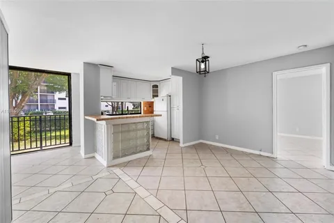 a view of a kitchen with furniture and a window