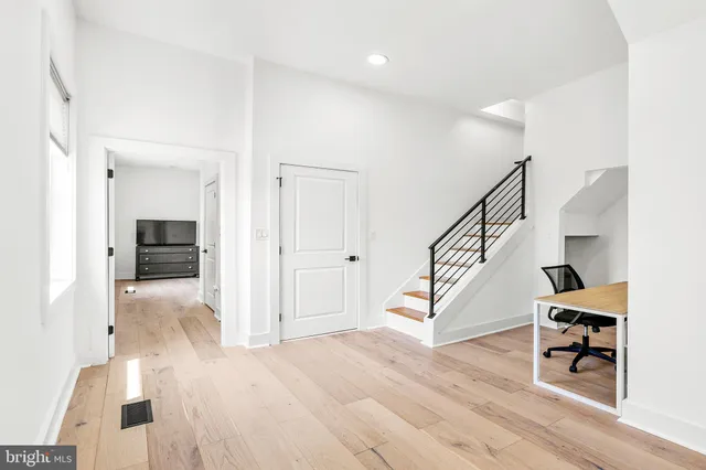 a view of entryway and hall with wooden floor