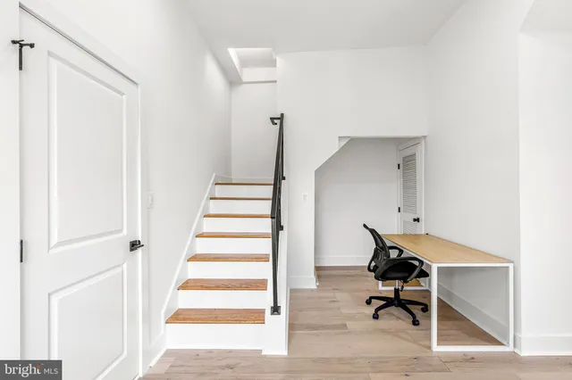 a view of entryway and hall with wooden floor