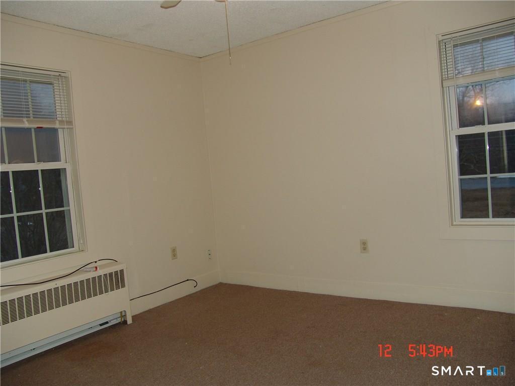 641 Wauregan Road Brooklyn, CT 06234 - Photo 6 of 22 Unit A, LR. Pictures are when unit was vacant. Currently Occupied.