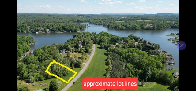 an aerial view of residential house with outdoor space and lake view