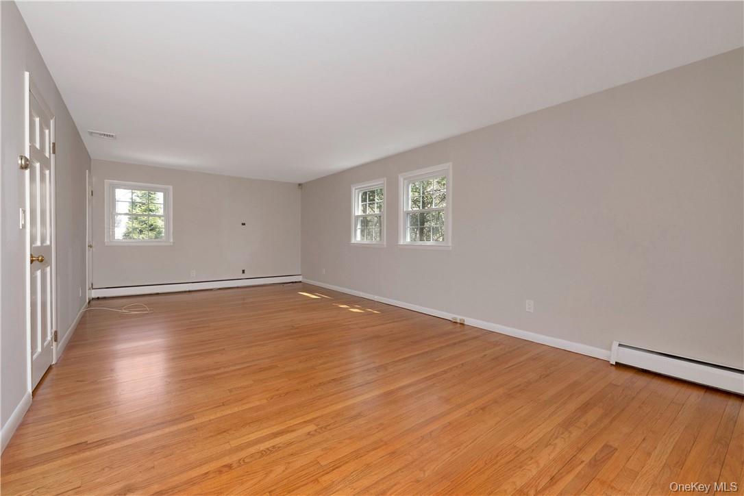3 Lea Place Rye, NY 10580 - Photo 13 of 32 an empty room with wooden floor and windows