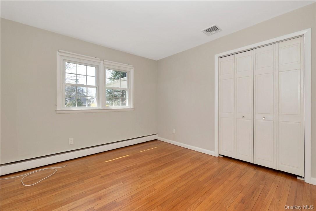 3 Lea Place Rye, NY 10580 - Photo 18 of 32 an empty room with wooden floor and windows