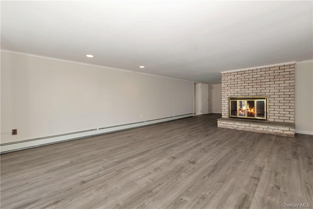 3 Lea Place Rye, NY 10580 - Photo 20 of 32 an empty room with wooden floor fireplace and windows