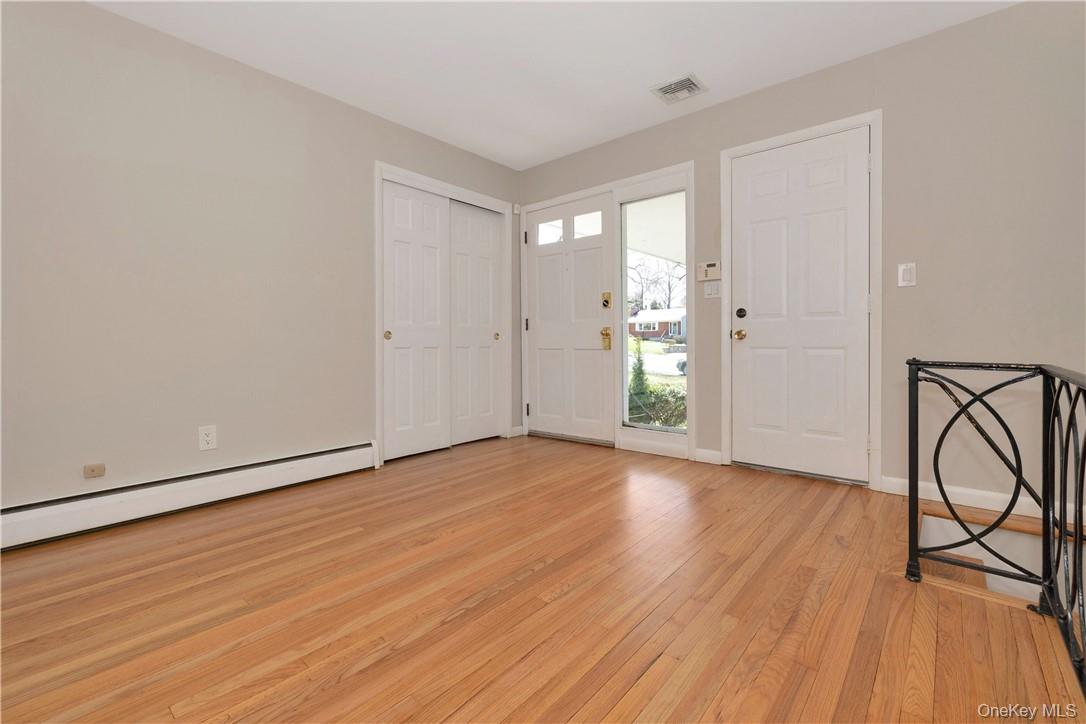 3 Lea Place Rye, NY 10580 - Photo 2 of 32 a view of an empty room with wooden floor and a window