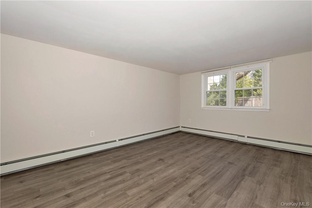3 Lea Place Rye, NY 10580 - Photo 21 of 32 an empty room with wooden floor and windows