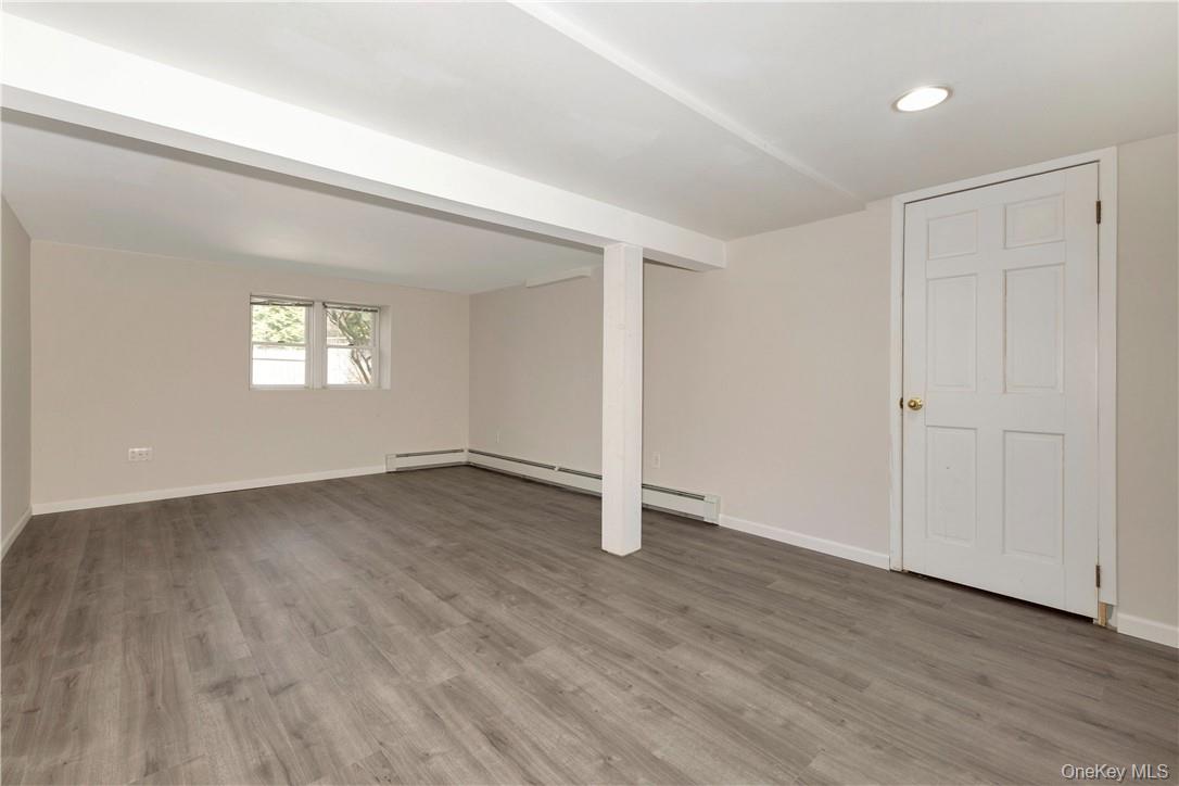 3 Lea Place Rye, NY 10580 - Photo 22 of 32 an empty room with wooden floor and window