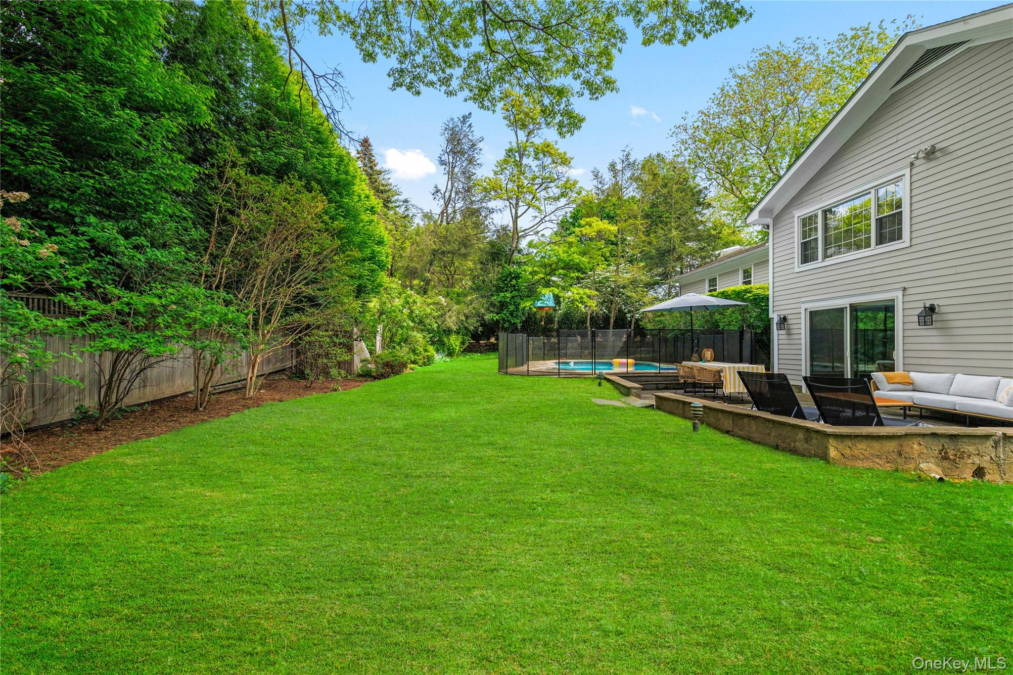 3 Lea Place Rye, NY 10580 - Photo 26 of 32 a view of backyard with swimming pool seating and green space