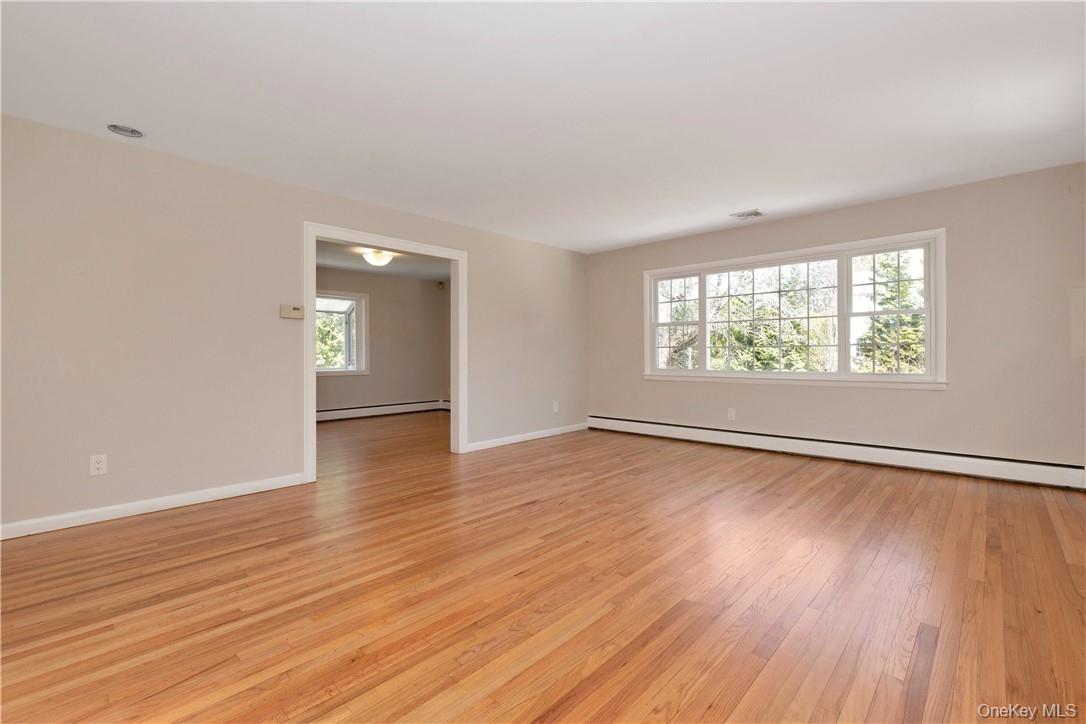 3 Lea Place Rye, NY 10580 - Photo 4 of 32 an empty room with wooden floor and windows