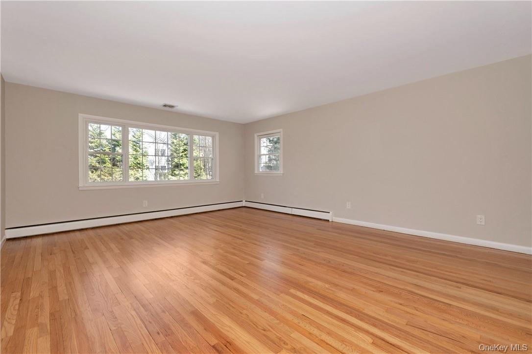 3 Lea Place Rye, NY 10580 - Photo 5 of 32 an empty room with wooden floor and windows