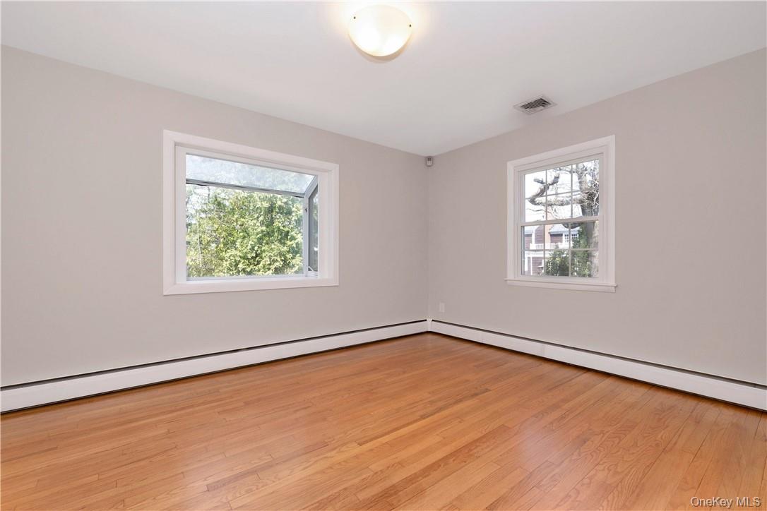 3 Lea Place Rye, NY 10580 - Photo 6 of 32 an empty room with wooden floor and windows