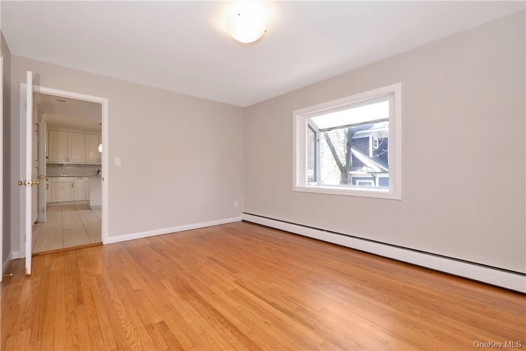 3 Lea Place Rye, NY 10580 - Photo 7 of 32 an empty room with wooden floor and windows