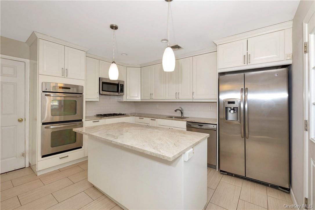 3 Lea Place Rye, NY 10580 - Photo 10 of 32 a kitchen with cabinets stainless steel appliances and a counter space