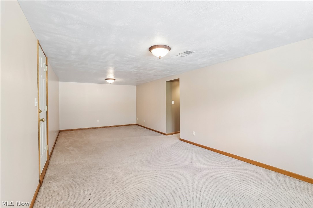 1638 South Cleveland Massillon Road Akron, OH 44321 - Photo 22 of 37 Spacious room with light-toned carpet flooring, neutral painted walls, and wood-trim baseboards