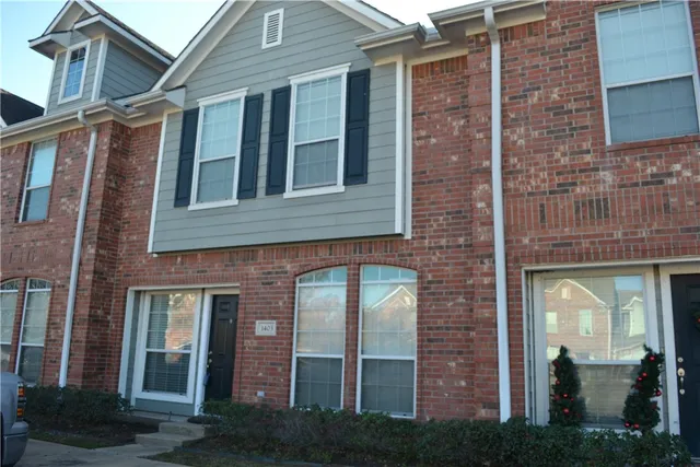 a view of a brick building next to a yard