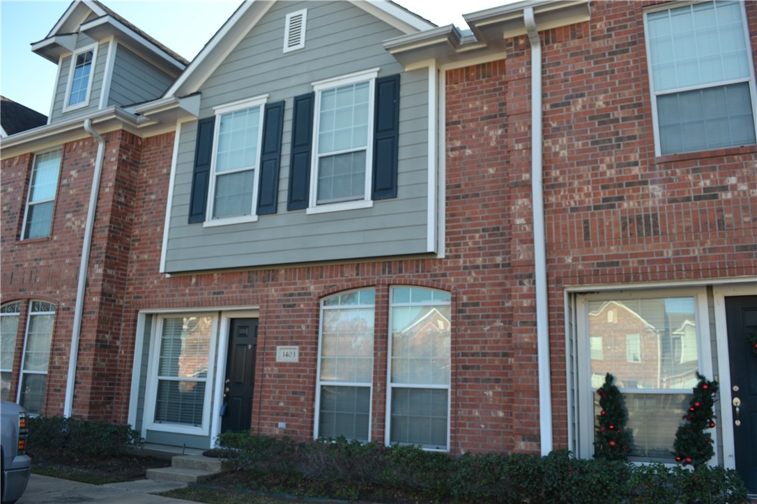 a view of a brick building next to a yard