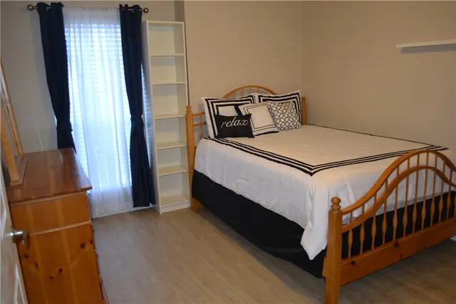 a bed sitting in a bedroom next to a window