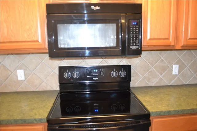 a stove top oven sitting inside of a kitchen