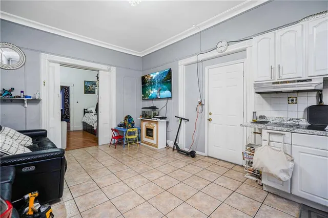 a hallway with a white stove top oven and cabinets