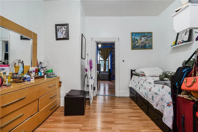 a bed room with a bed and a mirror on the dresser