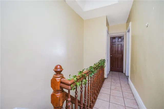 a hallway with flower pot and a potted plant