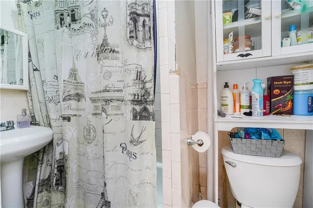 a bathroom with a toilet and a shower