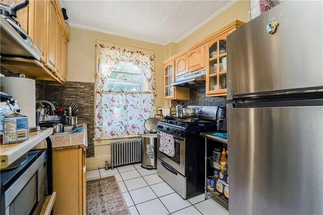 a kitchen with stainless steel appliances granite countertop a refrigerator and a stove